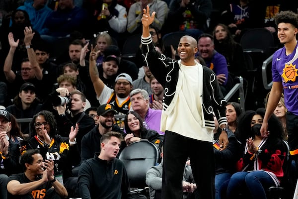 FILE - Phoenix Suns guard Chris Paul celebrates from the bench against the Brooklyn Nets during the first half of an NBA basketball game, Thursday, Jan. 19, 2023, in Phoenix. (AP Photo/Matt York, File)