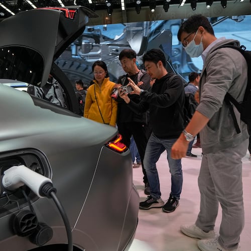 FILE - Visitors look at a Geely Galaxy E8 electric car during the Auto China 2024 in Beijing, Sunday, April 28, 2024. (AP Photo/Andy Wong, File)