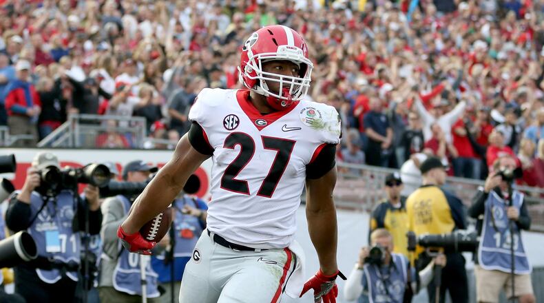PASADENA, CA - JANUARY 01:  Nick Chubb #27 of the Georgia Bulldogs celebrates after a 50-yard touchdown in the third quarter in the 2018 College Football Playoff Semifinal Game against the Oklahoma Sooners at the Rose Bowl Game presented by Northwestern Mutual at the Rose Bowl on January 1, 2018 in Pasadena, California.  (Photo by Matthew Stockman/Getty Images)