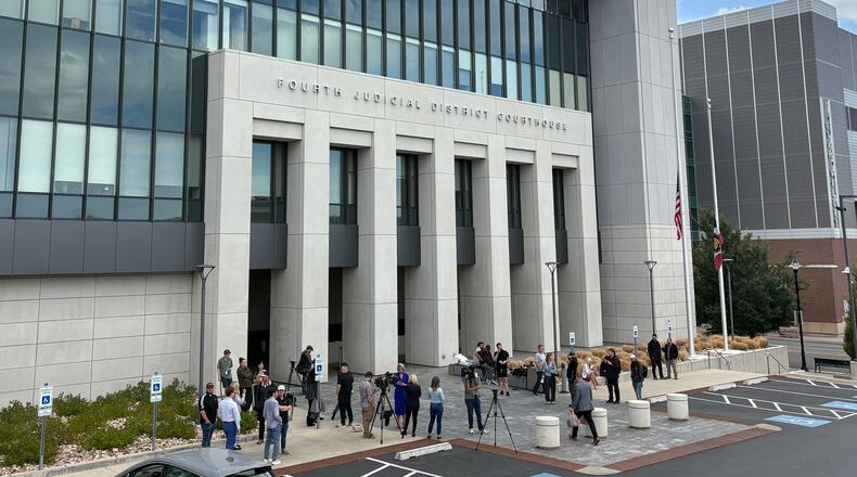 In this photo taken with a smartphone, people gather outside the Fourth Judicial District Courthouse in Provo, Utah, before a key hearing for Tyler Robinson, who is accused in the fatal shooting of Charlie Kirk, Tuesday, Sept. 1, 2026. (AP Photo/Hannah Schoenbaum)