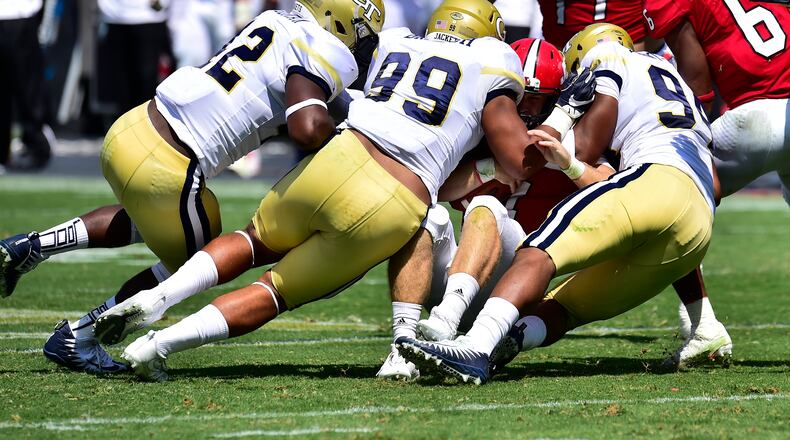 Bryant Horn of Jacksonville State is sacked by KeShun Freeman (42), Desmond Branch (99) and Anree Saint-Amour (94) of Georgia Tech on Sept. 9, 2017, at Bobby Dodd Stadium in Atlanta.