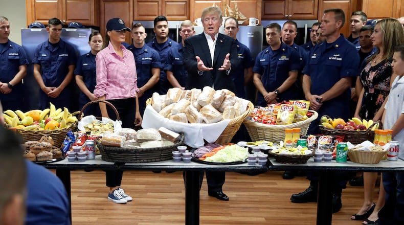 President Donald Trump, with first lady Melania Trump, speaks to members of the U.S. Coast Guard, at the Lake Worth Inlet Station, on Thanksgiving, Thursday, Nov. 23, 2017, in Riviera Beach, Fla. (AP Photo/Alex Brandon)