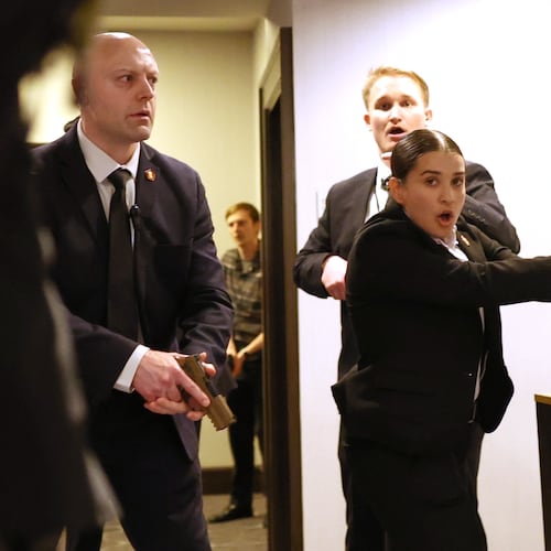 FILE - Secret service agents respond when a man, who authorities say, tried to storm the White House Correspondents' Association dinner with guns and knives, in Washington, April 25, 2026. (AP Photo/Tom Brenner, File)