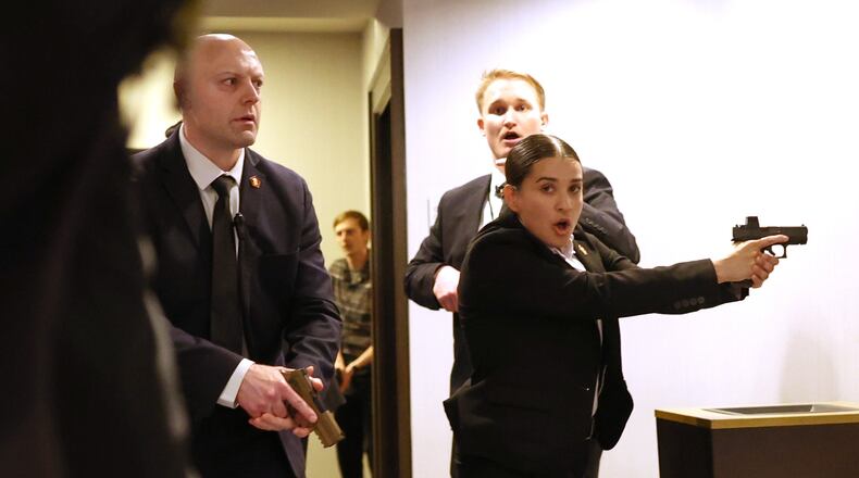 FILE - Secret service agents respond when a man, who authorities say, tried to storm the White House Correspondents' Association dinner with guns and knives, in Washington, April 25, 2026. (AP Photo/Tom Brenner, File)