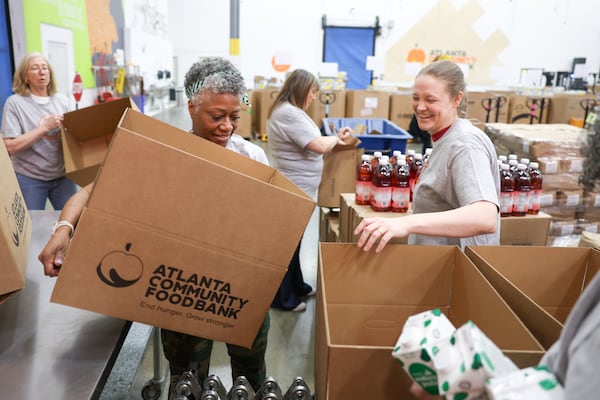 Legal professionals organize boxes for food donations at the Atlanta Community Food Bank in Atlanta. (Arvin Temkar/AJC)