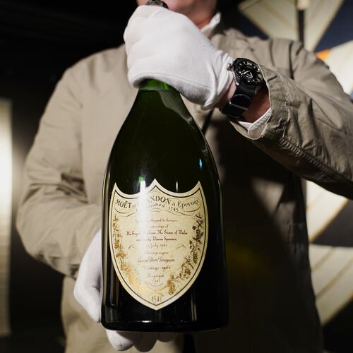 Thomas Rosendahl, head of wine department of Bruun Rasmussen auction house, holds a bottle of Dom Perignon Vintage 1961 champagne, specially produced for wedding of The Prince of Wales and Lady Diana in 1981, in Lyngby, Denmark, Wednesday, Dec. 3, 2025. (AP Photo/James Brooks)