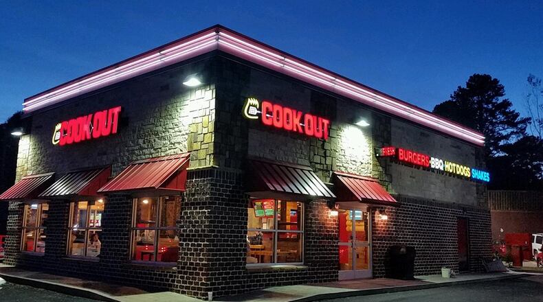 Two men were injured at a Cook Out in Lithonia after they argued with a man who shot each of them in the leg, police said. Both men are expected to recover and DeKalb police continue to search for the suspect.