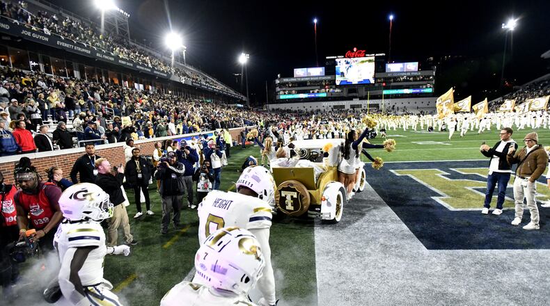 Georgia Tech players run onto the football field before an NCAA college between Georgia Tech and North Carolina State at Bobby Dodd Stadium, Thursday, November 21, 2024, in Atlanta. (Hyosub Shin / AJC)