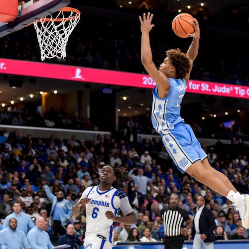 FILE - North Carolina guard Seth Trimble (7) dunks against Memphis during the Hoops for St. Jude Tip Off Classic NCAA college basketball exhibition game Tuesday, Oct. 15, 2024, in Memphis, Tenn. (AP Photo/Brandon Dill, File)