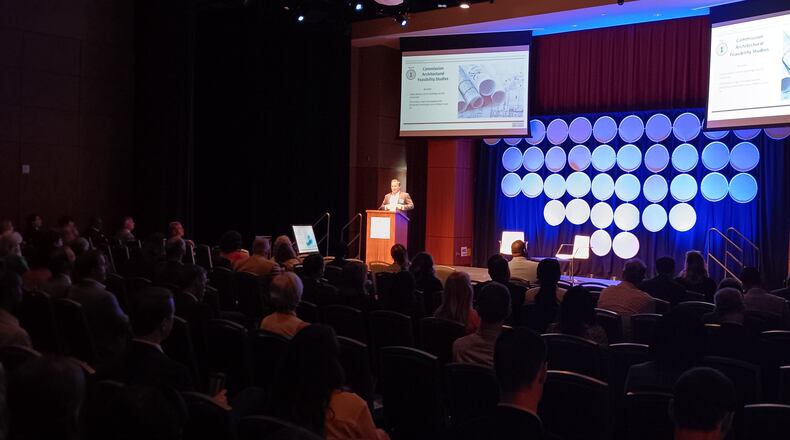Jonathan Tower from housing investment firm Arctaris Impact Investors talks to local government and business leaders at the INTERSECTION Quality Development Conference in Sandy Springs on Aug. 10, 2023.