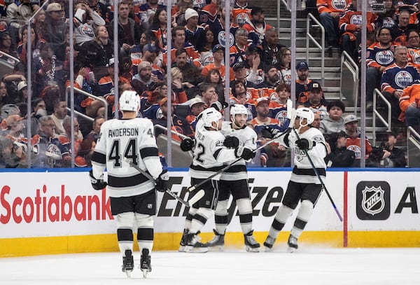 Los Angeles Kings' Mikey Anderson (44), Kevin Fiala (22), Alex Laferriere (14) and Quinton Byfield (55) celebrate a goal against the Edmonton Oilers during the second period of an NHL playoff game in Edmonton on Sunday, April 27, 2025. (Jason Franson/The Canadian Press via AP)