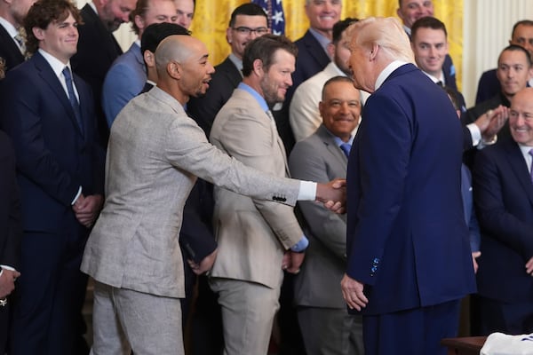 President Donald Trump, right, greets Los Angeles Dodgers' Mookie Betts during a ceremony to honor the Major League Baseball 2024 World Series Champion Los Angeles Dodgers in the East Room of the White House, Monday, April 7, 2025, in Washington. (AP Photo/Evan Vucci)