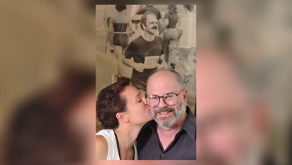 Barbi MacKinnon (and her father, Richard Greener with a picture of Greener when he ran the Peachtree Road Race in 1981, the year after he had his first heart attack.   (RICH ADDICKS/AJC staff)