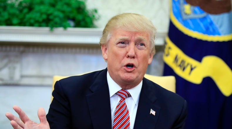 President Donald Trump speaks about domestic violence during a working session regarding the opportunity zones provided by tax reform in the Oval Office of the White House, Wednesday, Feb. 14, 2018, in Washington. Trump responded to a question and said, "I am totally opposed to domestic violence of any kind everyone knows that and it almost wouldn't even have to be said." (AP Photo/Manuel Balce Ceneta)