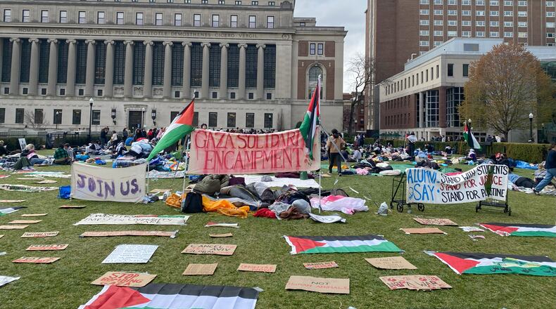 At Columbia University in New York, protesters erected signs on the newly occupied South Lawn, which stood throughout Thursday night and Friday. (Alice Tecotzky for The Atlanta Journal-Constitution)