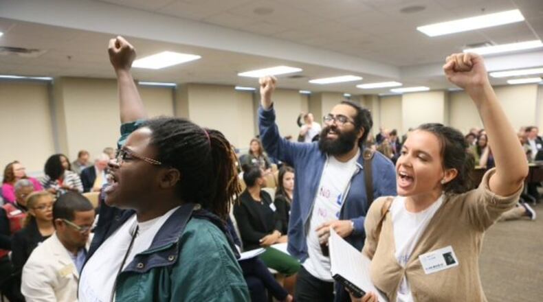 Students exit the Georgia Board of Regents after protesting a proposed vote on making Georgia Attorney General Sam Olens president of Kennesaw State University. BOB ANDRES/STAFF