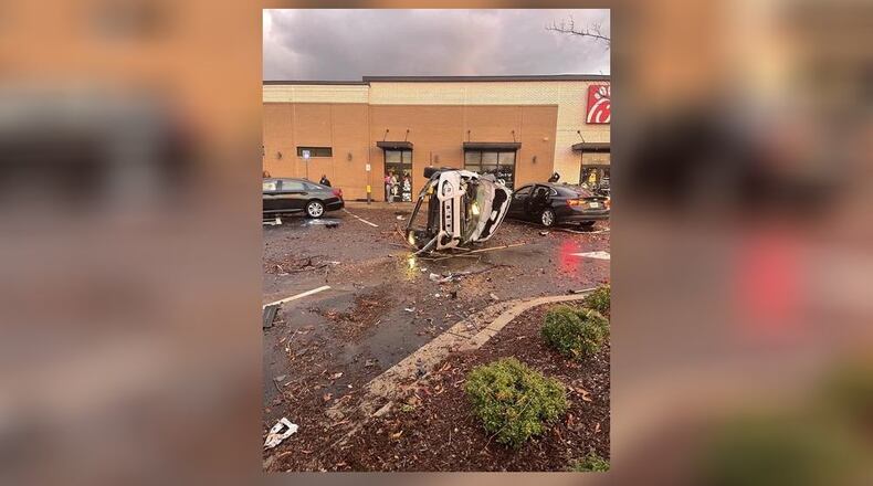 Powerful winds from a tornado overturned and damaged vehicles parked outside a Chick-fil-A in Newton County on Friday, the National Weather Service confirmed. (Credit: Channel 2 Action News)