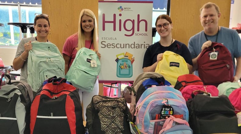 Volunteers with North Fulton Community Charities help sort and distribute new backpacks and school supplies for its annual Back to School campaign. (Courtesy North Fulton Community Charities)