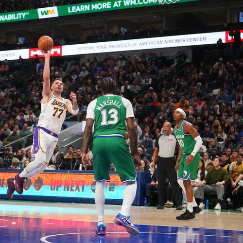 Los Angeles Lakers guard Luka Doncic (77) throws up a shot against Dallas Mavericks forward Naji Marshall (13) during the first half of an NBA basketball game Saturday, Jan. 24, 2026, in Dallas. (AP Photo/Julio Cortez)