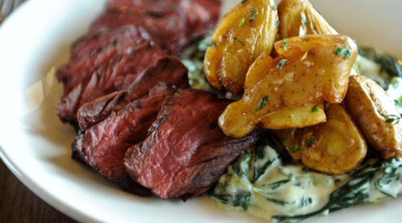 Hanger steak with smashed and fried potatoes and creamed collards at Chicken and the Egg in Marietta. The restaurant recently received national honors for its brunch offerings.