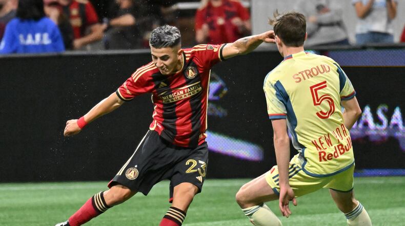 Atlanta United midfielder Thiago Almada (23) shoots against New York Red Bulls midfielder Peter Stroud (5) during the first half in a MLS soccer match at Mercedes-Benz Stadium, Saturday, April 1, 2023, in Atlanta. (Hyosub Shin / Hyosub.Shin@ajc.com)
