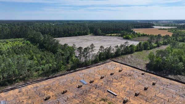 An aerial image taken on on Tuesday, April 21, 2026 shows, in the background, a field being prepared for planting by local resident and farmer Art Cothern. In the foreground is a field where Silicon Ranch is constructing one of the largest solar farms in the state. (Miguel Martinez/AJC)