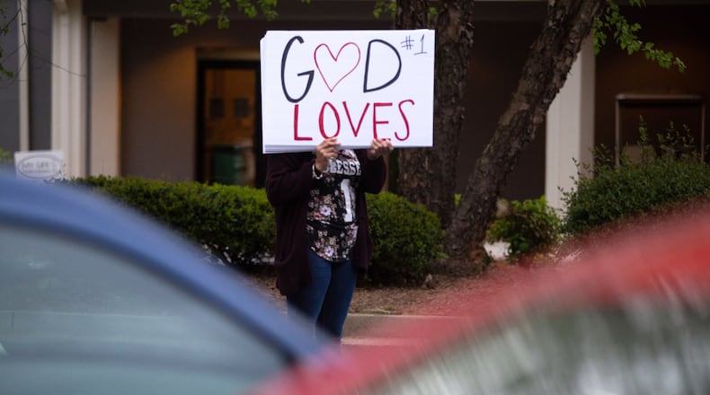 A touts God's love with a sign outside an Assemblies of God church in Atlanta in 2020. Assemblies of God and Atlanta Dream Center Church are accused in a new lawsuit of trafficking young members of theier ministry school. (Steve Schaefer / Special to the AJC)
