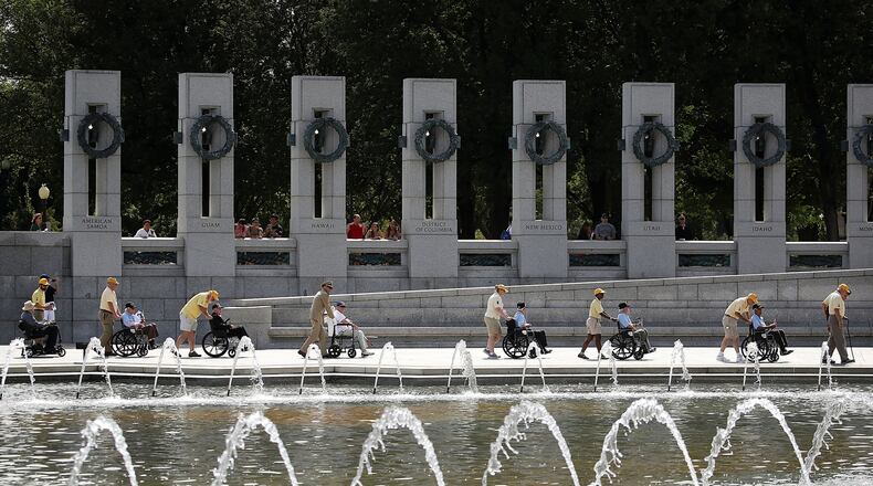 WWII veterans in wheel chairs are escorted during the annual V-J Day Observance to commemorate the Allied Forces victory in the Pacific and the end of World War II, at the World War II Memorial, on September 2, 2016 in Washington, DC.  (Photo by Mark Wilson/Getty Images)