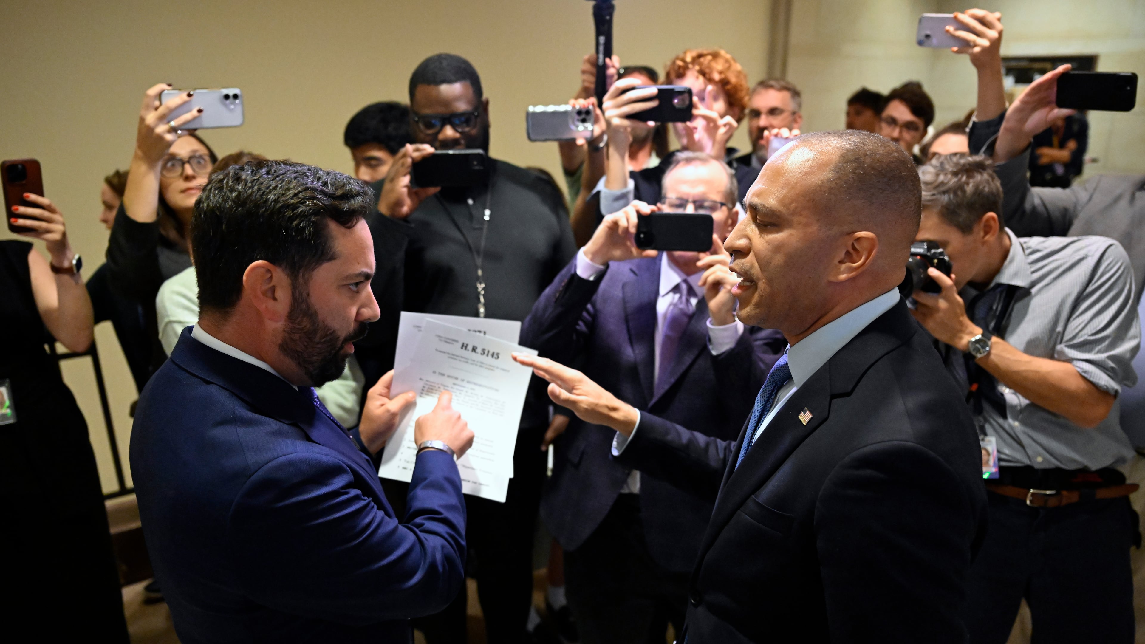Rep. Michael Lawler, R-N.Y., left, confronts House Minority Leader Hakeem Jeffries, D-N.Y., in a heated discussion to endorse House bill H.R.5145 that would extend the American Rescue Plan Act of 2021 (ARPA) and the Inflation Reduction Act of 2022 at the U.S. Capitol on Wednesday, Oct. 8, 2025, in Washington. (AP Photo/John McDonnell)