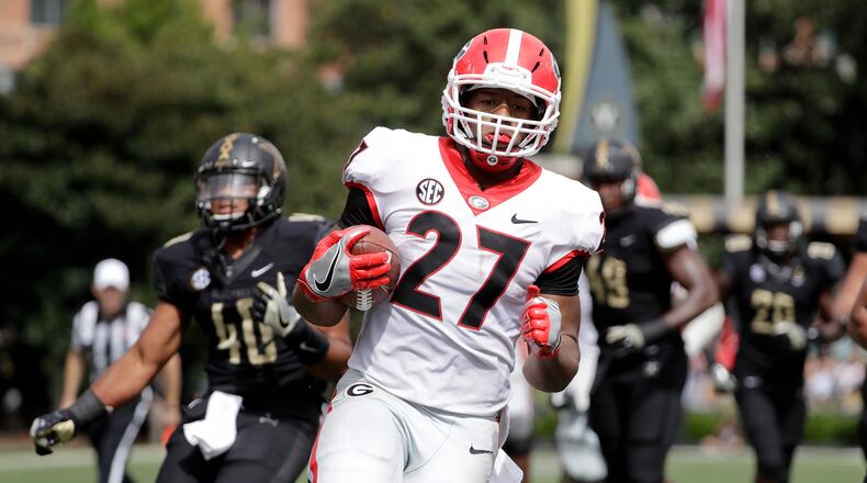 Georgia running back Nick Chubb (27) scores a touchdown against Vanderbilt on a 14-yard run in the first half of an NCAA college football game Saturday, Oct. 7, 2017, in Nashville, Tenn. (AP Photo/Mark Humphrey)