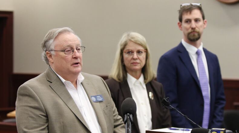 Jim Beck, the commissioner of the Georgia Insurance Department, speaks at a press conference about an insurance fraud bust in a courtroom at the Clayton County Superior Court in Jonesboro in March. Two months later, Beck was charged in a fraud case and was suspended. He continues to receive his $120,000-a-year salary. EMILY HANEY / emily.haney@ajc.com