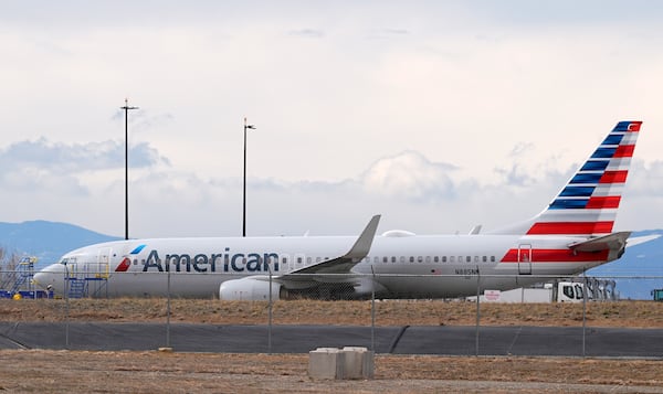 An American Airlines jetliner that caught fire after landing Thursday at Denver International Airport sits near a hangar at the airport Friday, March 14, 2025, in Denver. (AP Photo/David Zalubowski)