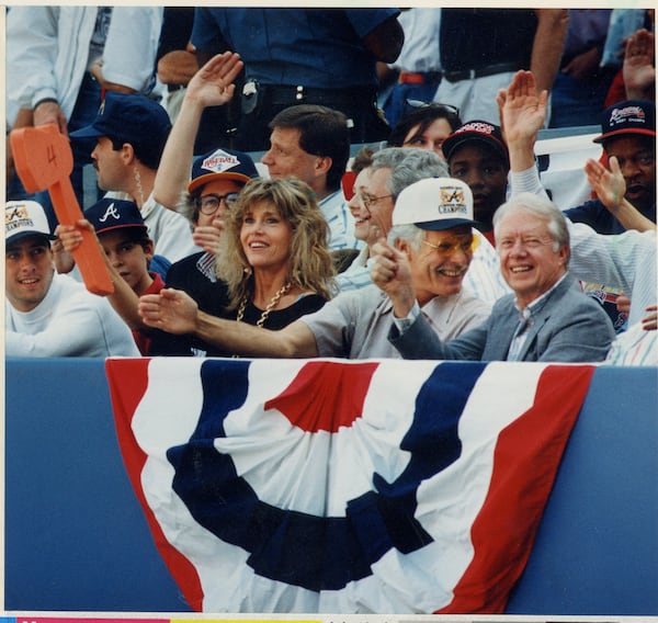 Jane Fonda, Braves owner Ted Turner and former President Jimmy Carter do the tomahawk chop at a Braves game in 1991. (Marlene Karas/AJC File)