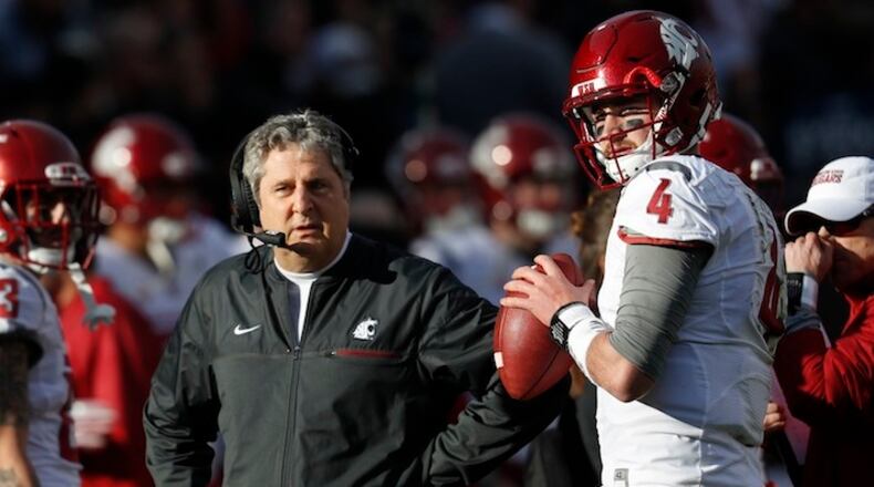 Washington State head coach Mike Leach, left, confers with quarterback Luke Falk during an injury time out against Colorado in the first half of an NCAA college football game Saturday, Nov. 19, 2016, in Boulder, Colo. (AP Photo/David Zalubowski)