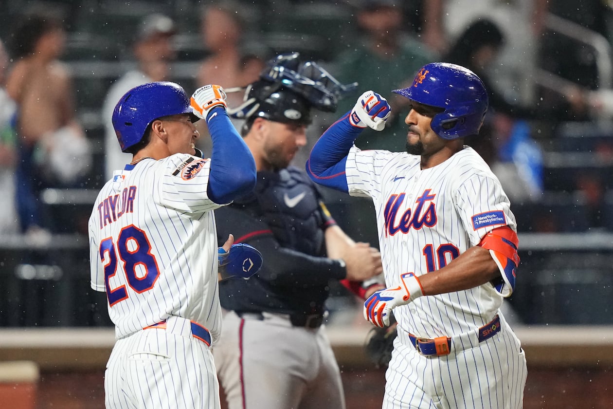 Mets center fielder Tyrone Taylor (left) celebrates with second baseman Marcus Semien after Semien hit a two-run home against the Braves on Monday, July 27, 2026, in New York. (Frank Franklin II/AP)