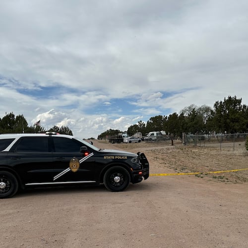 A New Mexico State Police vehicle blocks off a neighborhood in Mountainair, N.M., where authorities say several people died Wednesday, May 20, 2026, and more than a dozen first responders were exposed to an unknown substance and later treated at a hospital. (AP Photo/Savannah Peters)