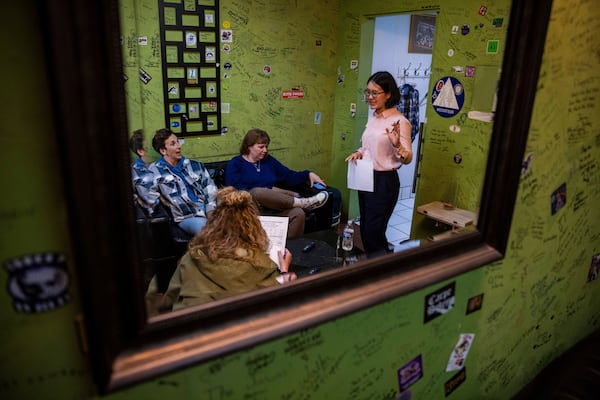 From left, Kaycee Conlee, Ashley Brooke Roberts and emcee Corinna Yee prepare before Stand Up For Climate, a comedy show at Flappers Comedy on Thursday, March 20, 2025, in Burbank, Calif. (AP Photo/Ethan Swope)