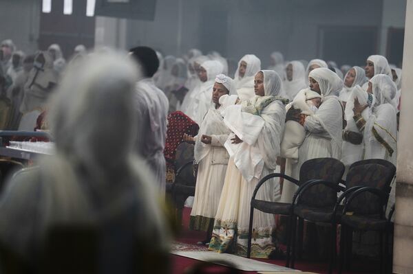 Congregants stand to receive Communion at Re'ese Adbarat Debre Selam Kidist Mariam Church, an Ethiopian Orthodox Tewahedo church, in Washington, D.C., Saturday, April 5, 2025. (AP Photo/Jessie Wardarski)