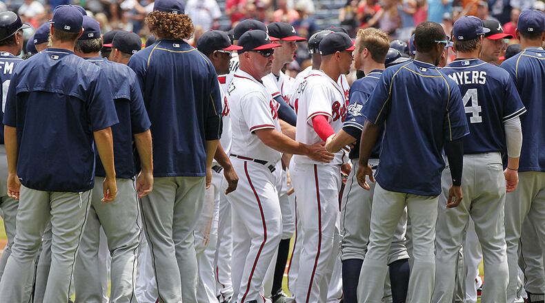 Braves manager Fredi Gonzalez (center) helps break up a bench-clearing confrontation after Braves pitcher Julio Teheran hit Padres batter Matt Kemp with a pitch during the first inning Thursday, June 11, 2015, at Turner Field in Atlanta.