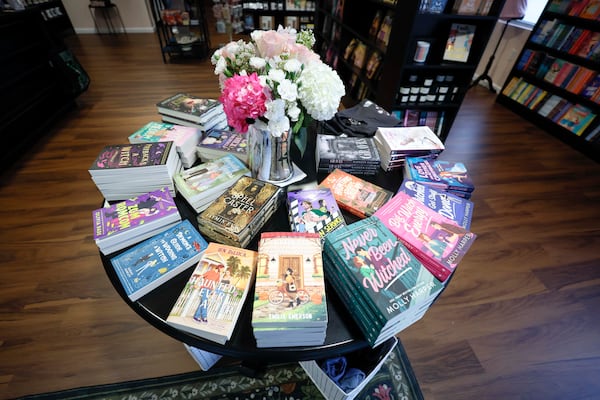 Books by several authors are displayed inside the Kiss and Tale bookstore on Thursday, October 9, 2025, in Decatur. The new bookstore, which opened on September 6, features a selection of romance titles and other genres. (Miguel Martinez/AJC)