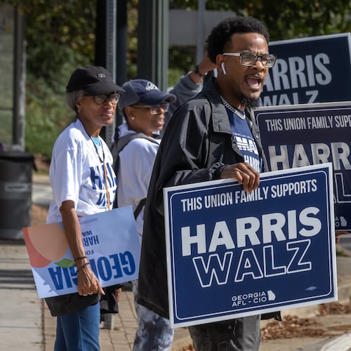 Rasheed Wingo (right), with the Atlanta North Georgia Labor Council, campaigns at the C.T. Martin Natatorium and Recreation Center on Election Day 2024. The state of Georgia was on track to break voter turnout records as presidential candidates, Republican Donald Trump and Democrat Kamala Harris, went head-to-head in this pivotal swing state. (John Spink/AJC 2024)