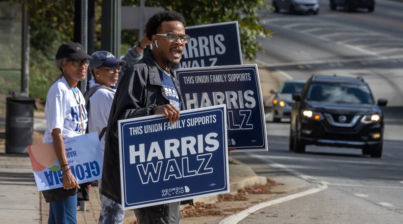 Rasheed Wingo (right), with the Atlanta North Georgia Labor Council, campaigns at the C.T. Martin Natatorium and Recreation Center on Election Day 2024. The state of Georgia was on track to break voter turnout records as presidential candidates, Republican Donald Trump and Democrat Kamala Harris, went head-to-head in this pivotal swing state. (John Spink/AJC 2024)