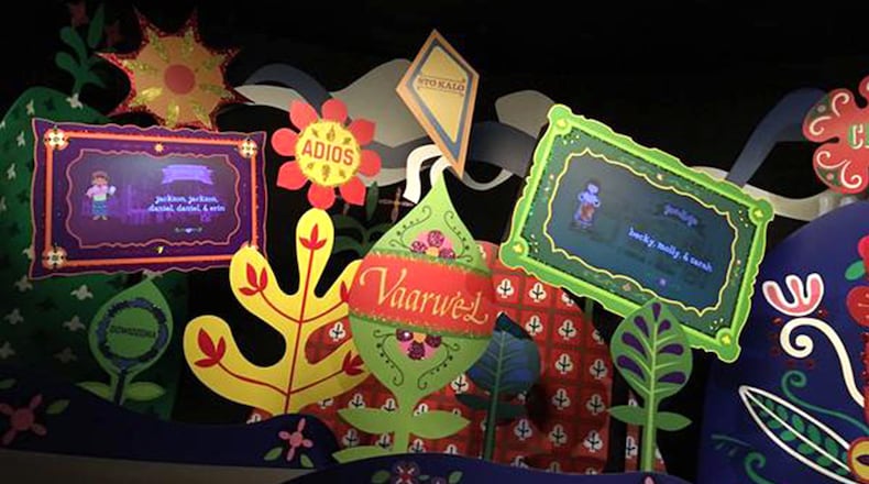 Signs near the end of Magic Kingdom’s “it’s a small world” display names of riders wearing MagicBands. (Dewayne Bevil/Orlando Sentinel/TNS)