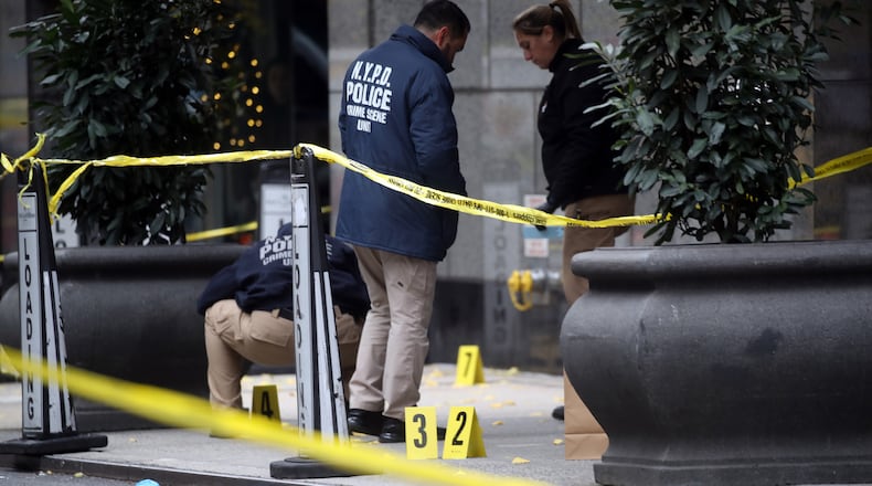 Police place bullet casing markers outside of a Hilton Hotel in Midtown Manhattan where United Healthcare CEO Brian Thompson was fatally shot on Dec. 4, 2024, in New York. (Spencer Platt/Getty Images/TNS)