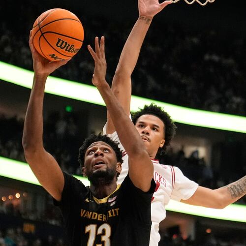 FILE - Vanderbilt forward Jalen Washington (13) shoots the ball past Arkansas forward Malique Ewin, right, during the first half of an NCAA college basketball game in the final of the Southeastern Conference tournament March 15, 2026, in Nashville, Tenn. (AP Photo/George Walker IV, File)