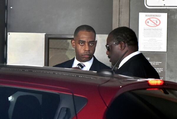 Atlanta’s former chief purchasing officer, Adam Smith (left), leaves the federal courthouse in September after pleading guilty to conspiracy for accepting bribes. HYOSUB SHIN / HSHIN@AJC.COM