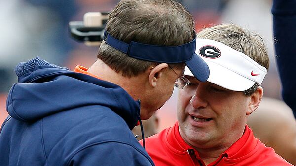In this Nov. 11, 2017, file photo, Auburn head coach Gus Malzahn, left, and Georgia head coach Kirby Smart, right, meet before an NCAA college football game in Auburn, Ala. No. 6 Georgia is getting ready for a rematch with No. 4 Auburn in the SEC championship game. (AP Photo/Brynn Anderson, File)