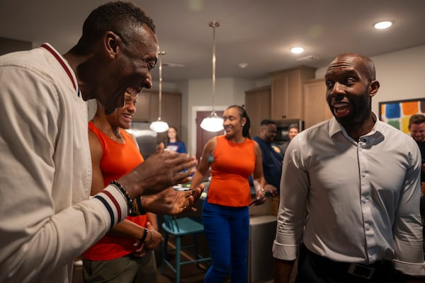 Friends, campaign staff and supporters celebrate after former Gwinnett County School Board Chair Everton Blair Jr. (right) wins the special election runoff for Georgia's 13th Congressional District on Tuesday. (Olivia Bowdoin for the AJC)