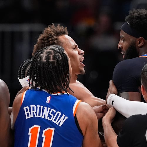 New York Knicks center Mitchell Robinson (23) and Atlanta Hawks guard Dyson Daniels (5) fight in the first half during Game 6 in a first-round NBA basketball playoffs series Thursday, April 30, 2026, in Atlanta. (AP Photo/Brynn Anderson)