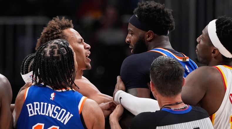 New York Knicks center Mitchell Robinson (23) and Atlanta Hawks guard Dyson Daniels (5) fight in the first half during Game 6 in a first-round NBA basketball playoffs series Thursday, April 30, 2026, in Atlanta. (AP Photo/Brynn Anderson)